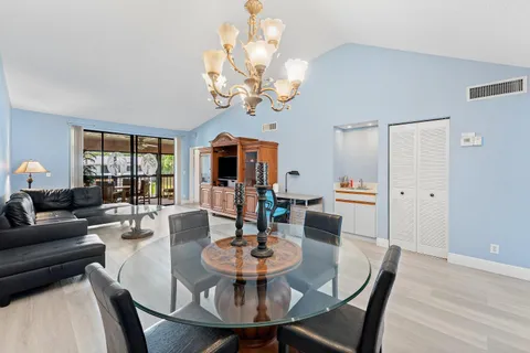 a living room with furniture a flat screen tv and a large window