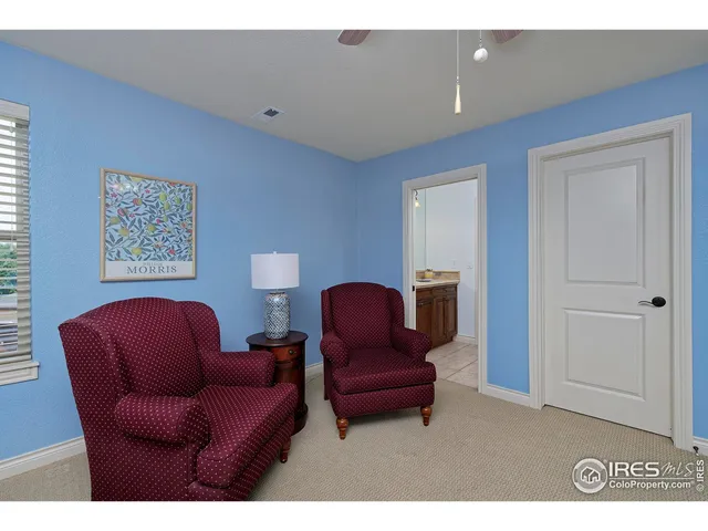 a living room with furniture and a chair