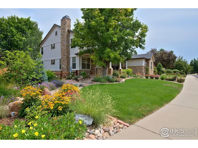 a view of a house with backyard sitting area and garden
