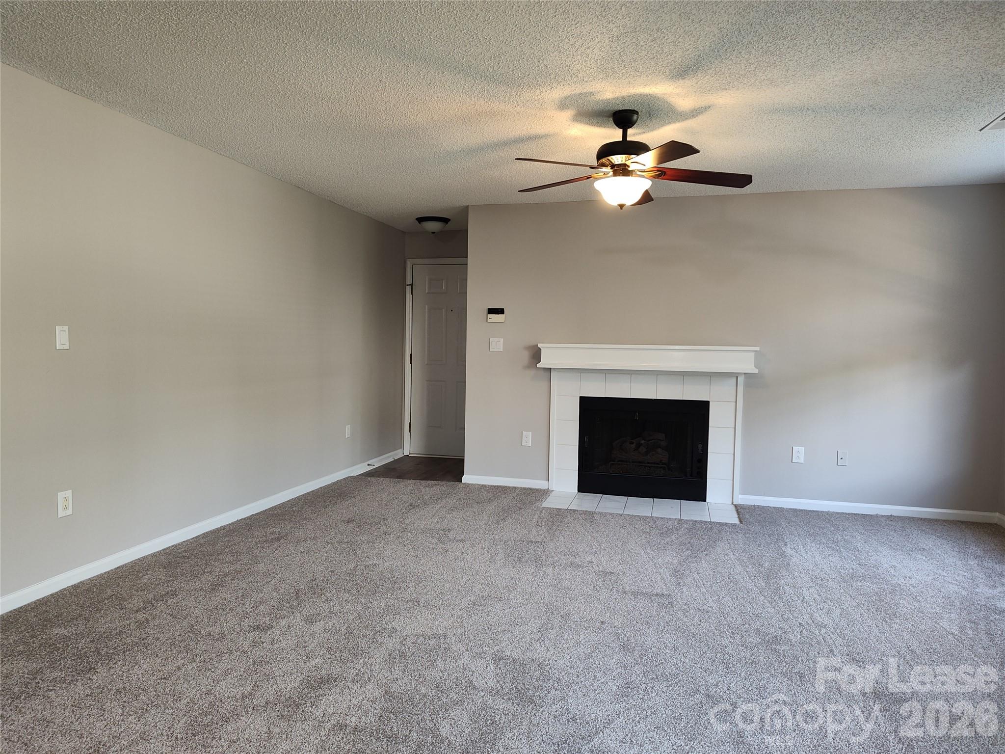 5001 Sharon Road, Unit K Charlotte, NC 28210 - Photo 11 of 24 a view of an empty room with a fireplace