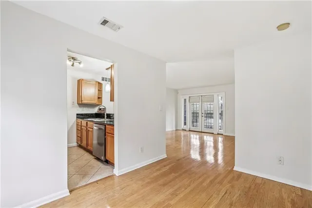a view of empty room with wooden floor
