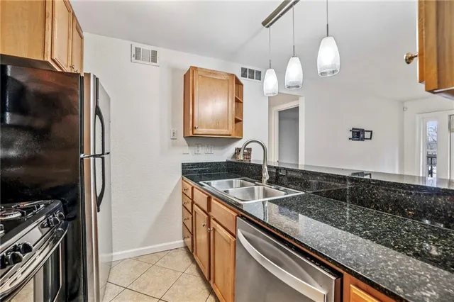 a kitchen with a refrigerator and a sink