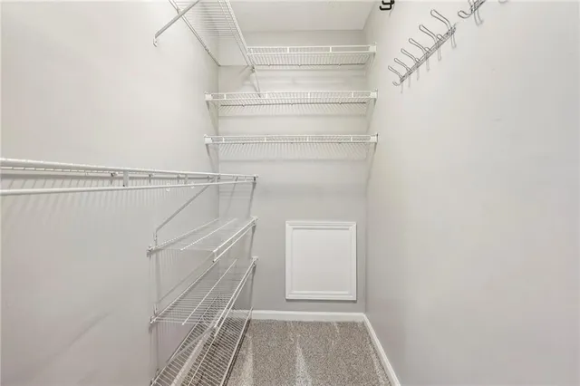 a bathroom with a granite countertop sink a toilet a mirror and shower