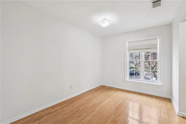 an empty room with windows and closet