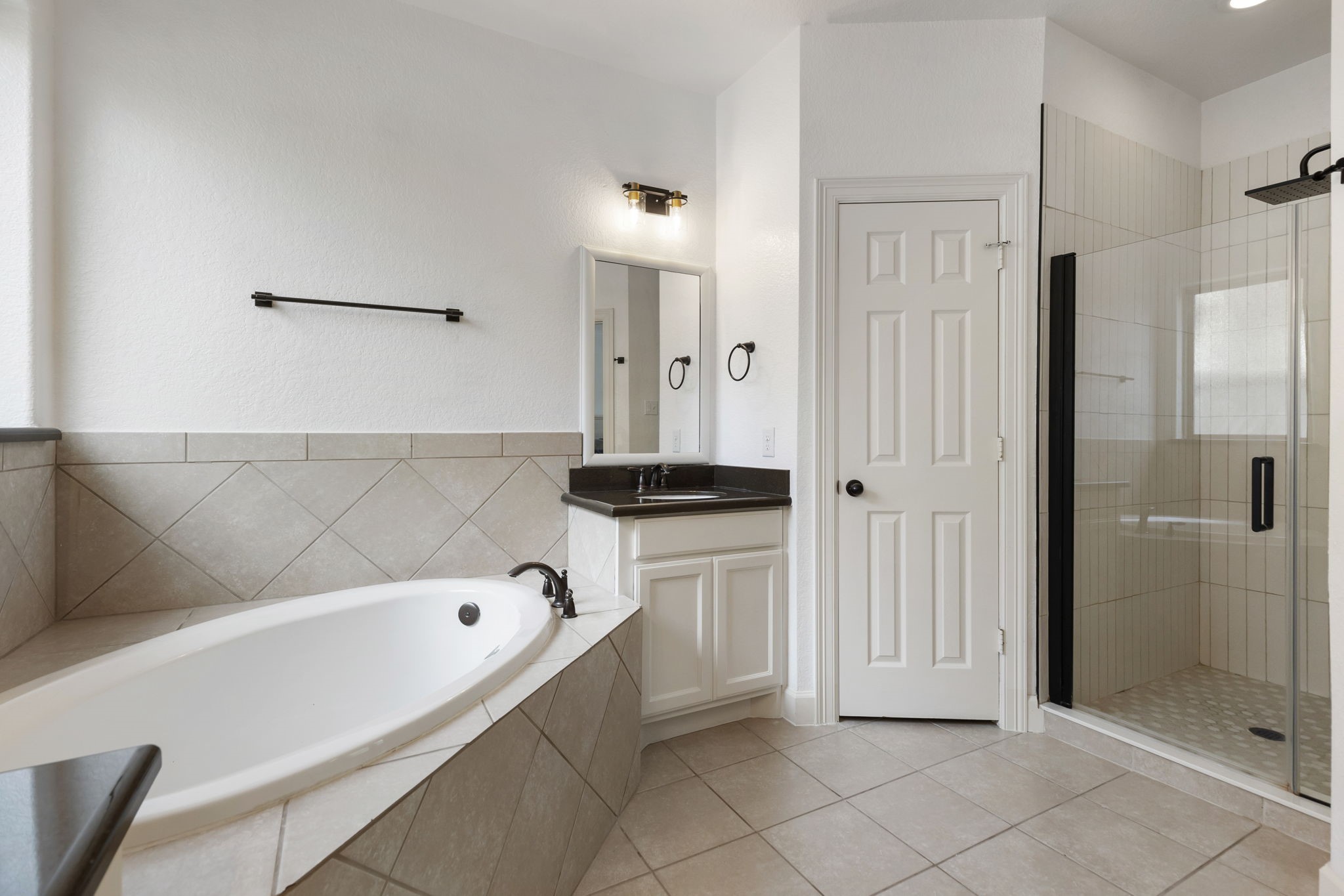 71 Sagamore Ridge Place The Woodlands, TX 77389 - Photo 24 of 34 a bathroom with a bathtub and a shower