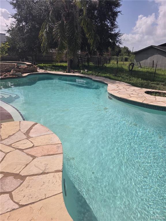 2210 West Monte Cristo Road Edinburg, TX 78541 - Photo 5 of 11 a view of a swimming pool with a yard
