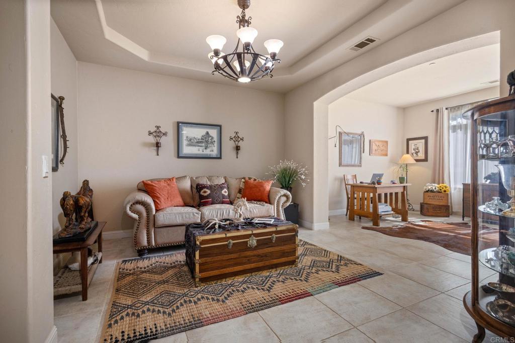 10204 Mt Olympus Valley Road Fallbrook, CA 92028 - Photo 11 of 59 a spacious bedroom with furniture and a chandelier