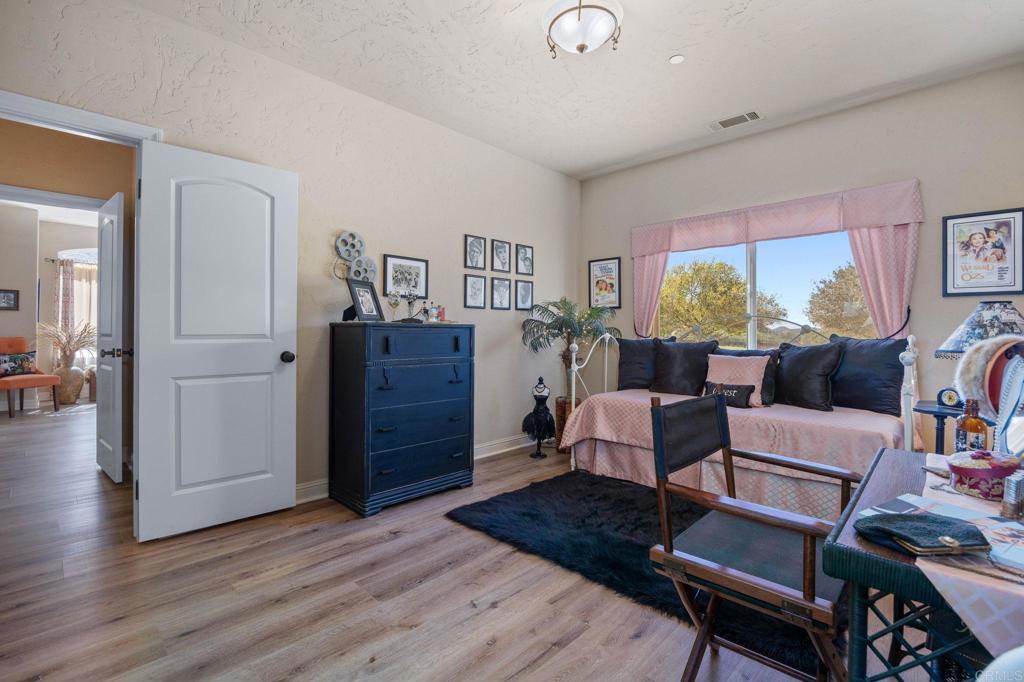 10204 Mt Olympus Valley Road Fallbrook, CA 92028 - Photo 32 of 59 a living room with furniture and wooden floor