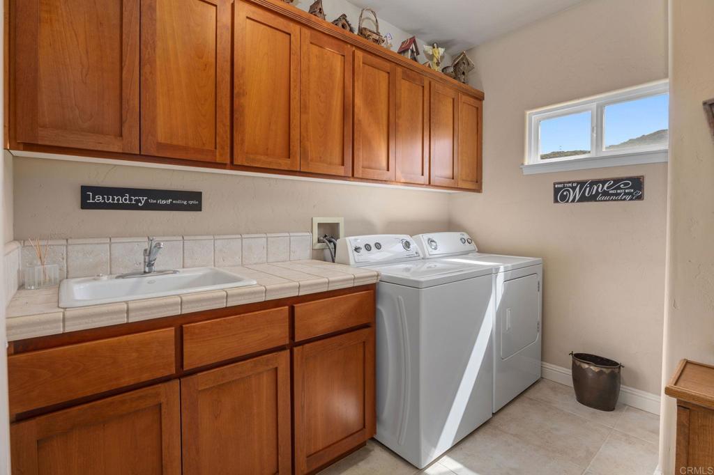 10204 Mt Olympus Valley Road Fallbrook, CA 92028 - Photo 36 of 59 a utility room with a sink washer and dryer