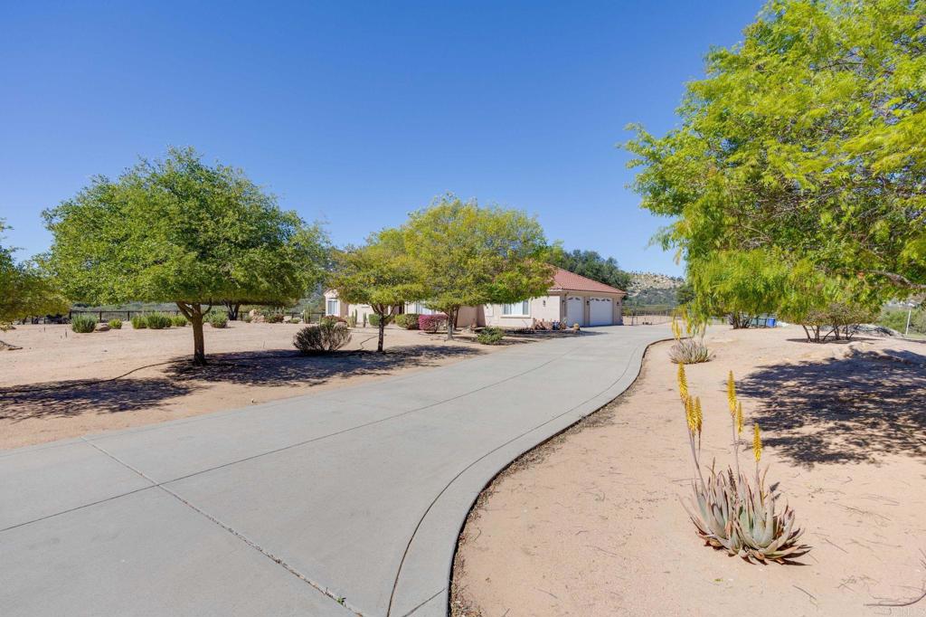 10204 Mt Olympus Valley Road Fallbrook, CA 92028 - Photo 5 of 59 a view of a road with a building in the background