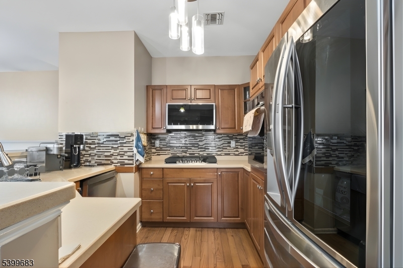 159 George Russell Way Clifton, NJ 07013 - Photo 11 of 25 a kitchen with stainless steel appliances granite countertop a refrigerator and a sink