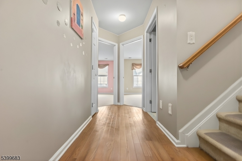 159 George Russell Way Clifton, NJ 07013 - Photo 15 of 25 a view of a hallway with wooden floor and staircase