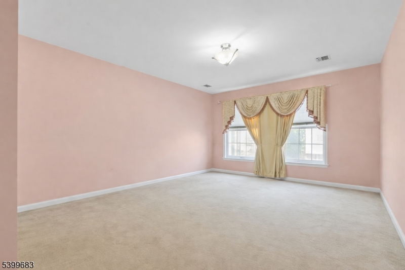 159 George Russell Way Clifton, NJ 07013 - Photo 16 of 25 an empty room with a window and a ceiling fan