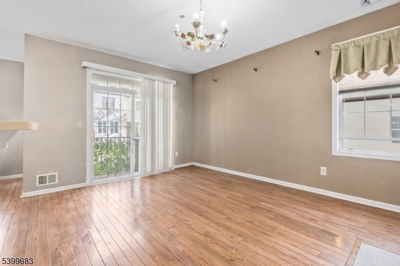 159 George Russell Way Clifton, NJ 07013 - Photo 5 of 25 a view of an empty room with wooden floor and a window