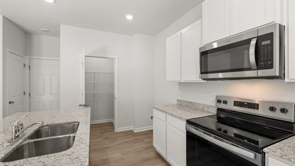 104 Oak View Lane Dallas, GA 30157 - Photo 12 of 39 a kitchen with stainless steel appliances granite countertop a stove microwave and sink
