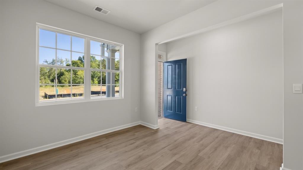 104 Oak View Lane Dallas, GA 30157 - Photo 4 of 39 a view of an empty room with wooden floor and a window