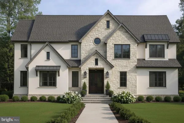 a front view of a house with a yard and trees
