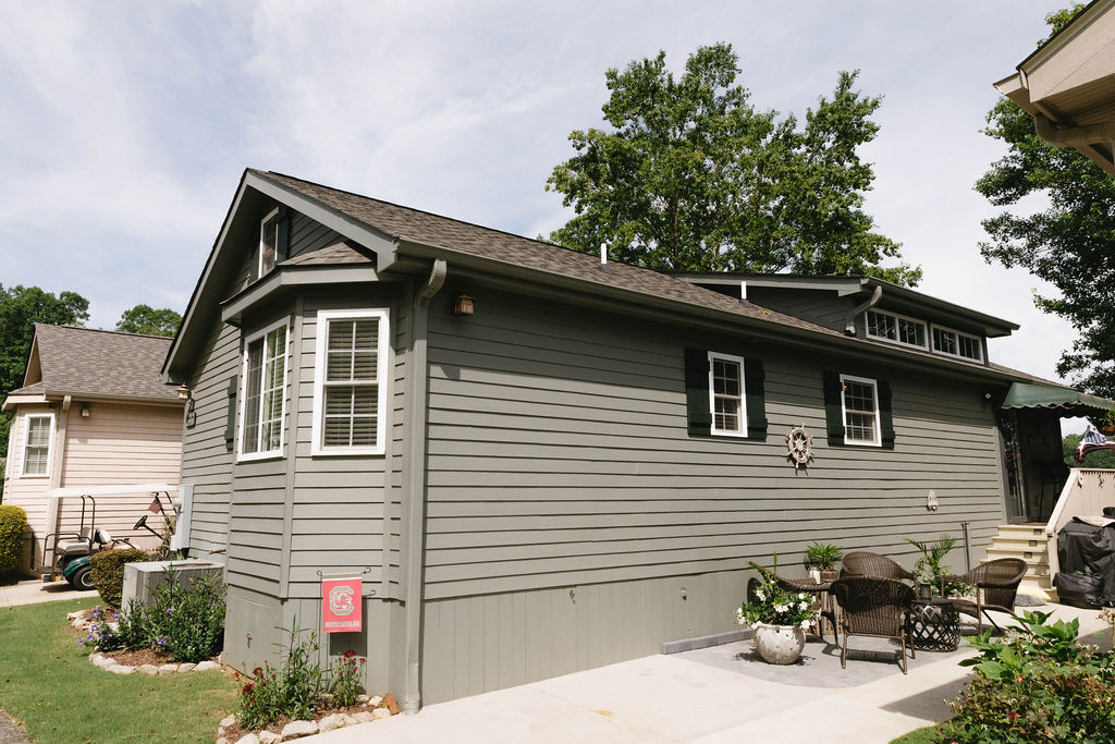 This charming home features classic horizontal siding and a neatly maintained patio area.