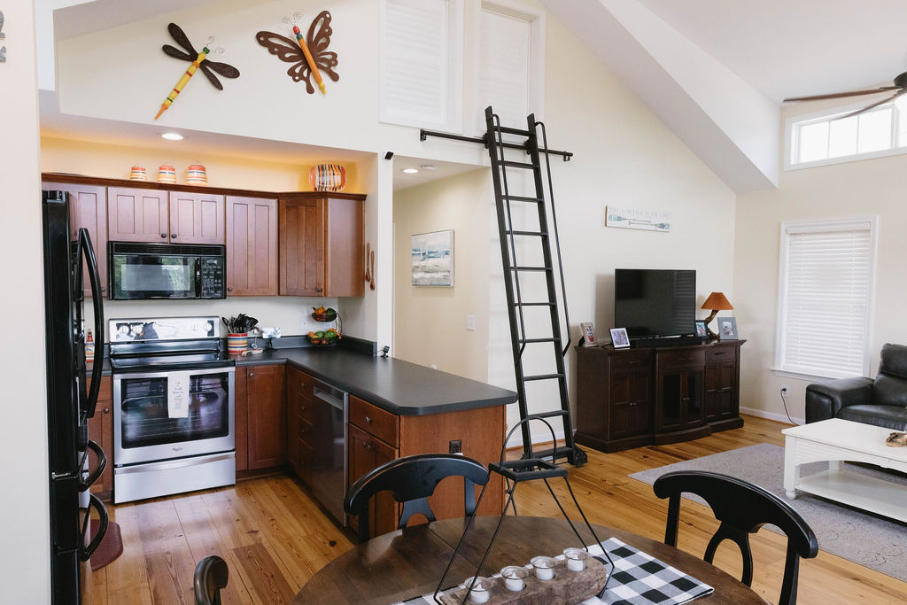 1230 Melton Road, Unit 87 West Union, SC 29696 - Photo 15 of 43 This open-concept area features a kitchen and living space with high ceilings and warm wood flooring.