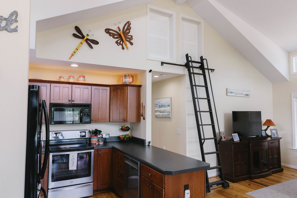 1230 Melton Road, Unit 87 West Union, SC 29696 - Photo 34 of 43 This open concept space features a kitchen and living area with vaulted ceilings and ample natural light.
