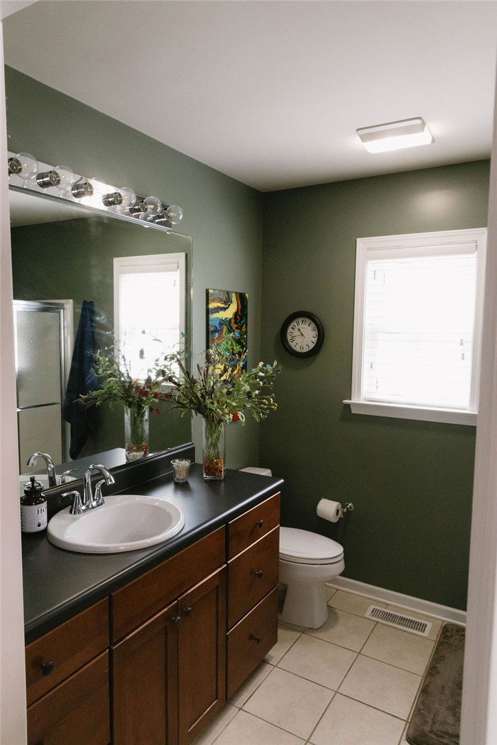1230 Melton Road, Unit 87 West Union, SC 29696 - Photo 10 of 43 This bathroom features a single vanity, a toilet, and a shower with tiled flooring.