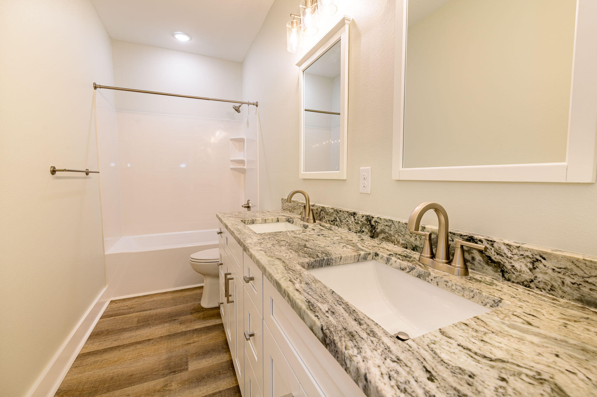 107 Clearing Way Valparaiso, FL 32580 - Photo 14 of 22 a bathroom with a granite countertop sink a mirror and a shower