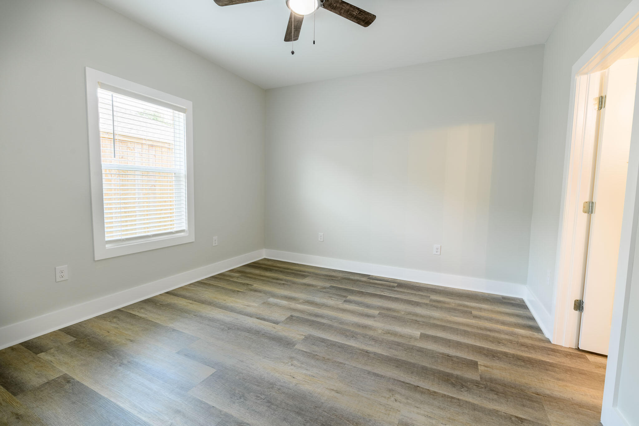 107 Clearing Way Valparaiso, FL 32580 - Photo 16 of 22 wooden floor in an empty room with a window