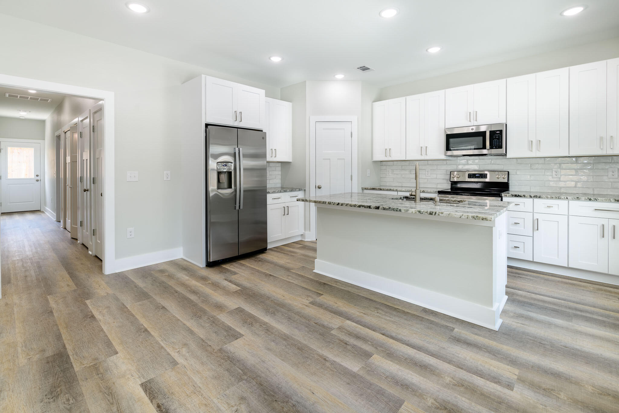 107 Clearing Way Valparaiso, FL 32580 - Photo 4 of 22 a kitchen with stainless steel appliances granite countertop a stove a sink and a refrigerator