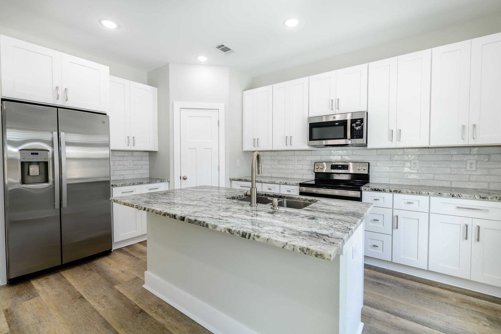 107 Clearing Way Valparaiso, FL 32580 - Photo 5 of 22 a kitchen with kitchen island granite countertop a sink a counter top space stainless steel appliances and cabinets