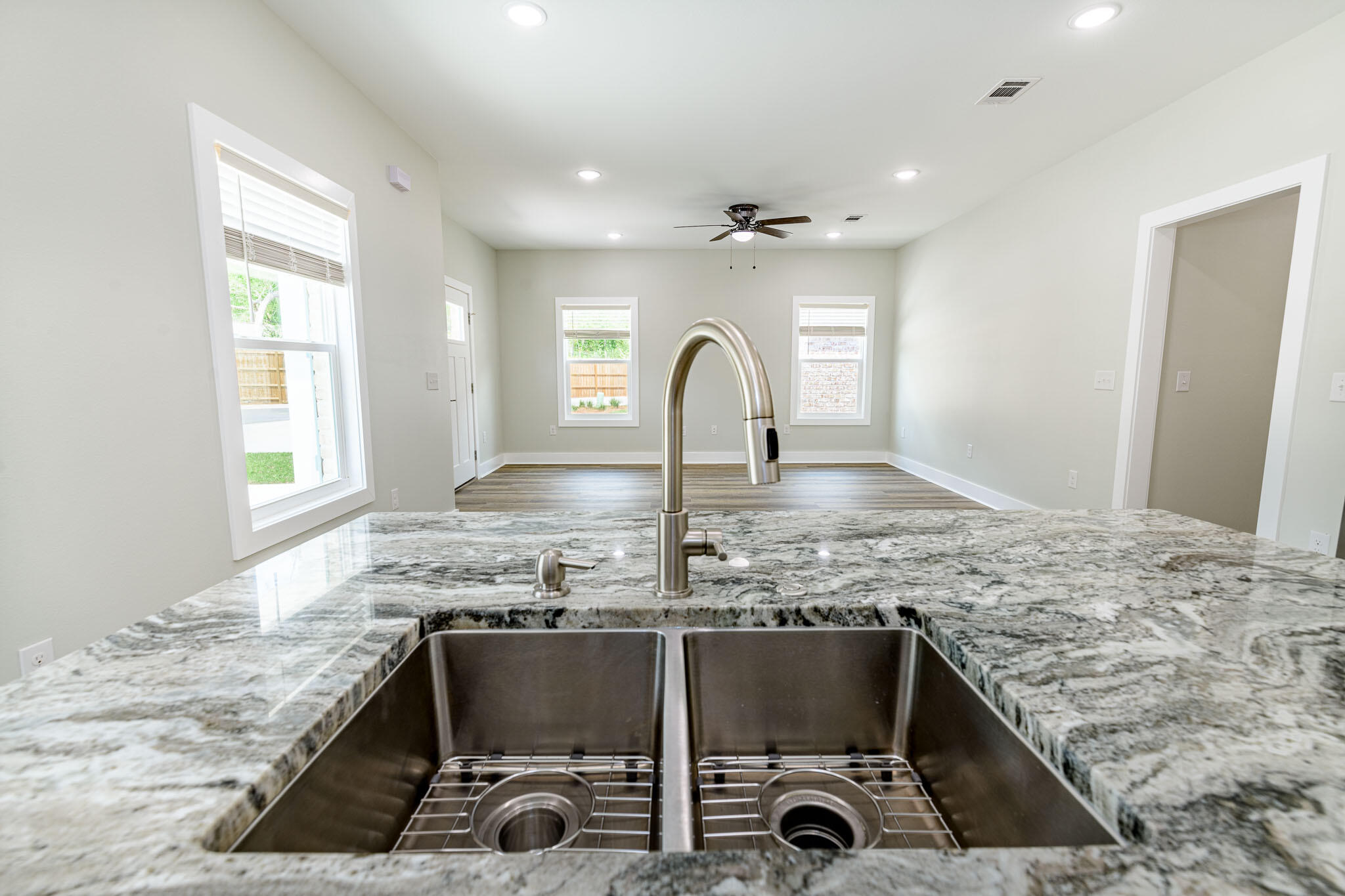 107 Clearing Way Valparaiso, FL 32580 - Photo 6 of 22 a kitchen with kitchen island granite countertop a stove a sink and a granite counter tops