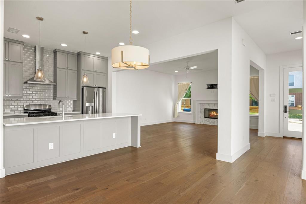 2125 Bird Street Fort Worth, TX 76111 - Photo 11 of 34 a large kitchen with stainless steel appliances kitchen island a large island in the center
