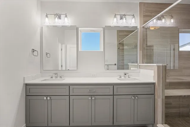 a bathroom with double sink and a mirror