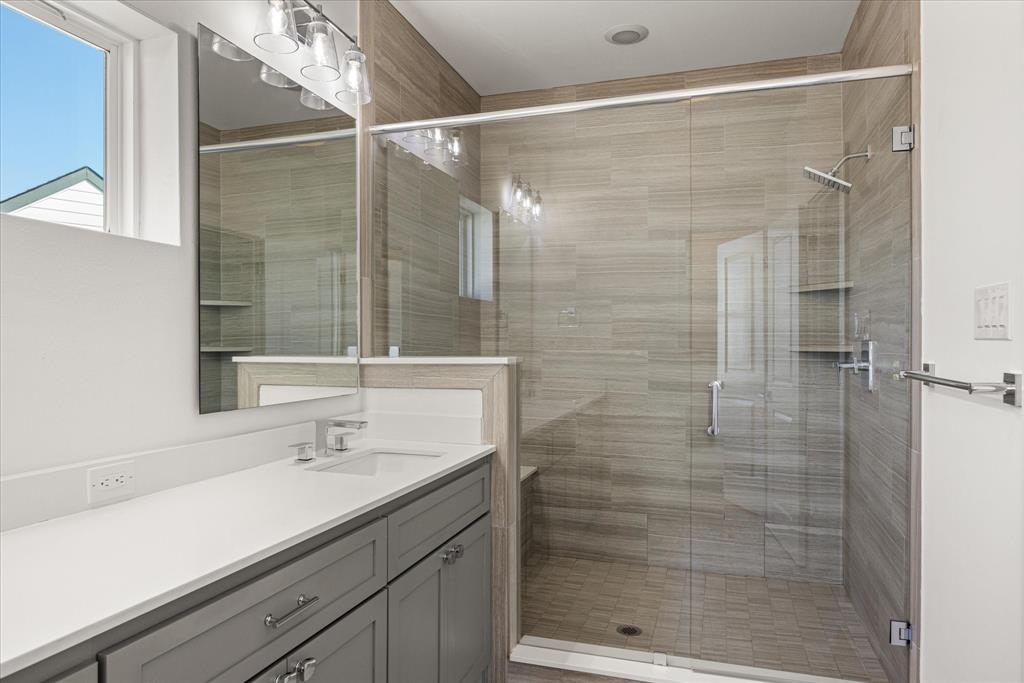 2125 Bird Street Fort Worth, TX 76111 - Photo 20 of 34 a bathroom with a shower sink and mirror