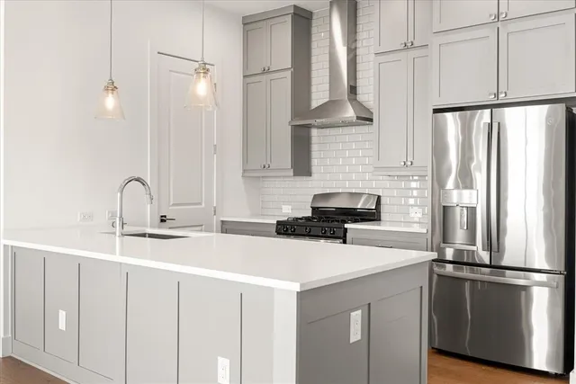 a kitchen with stainless steel appliances a sink and a refrigerator