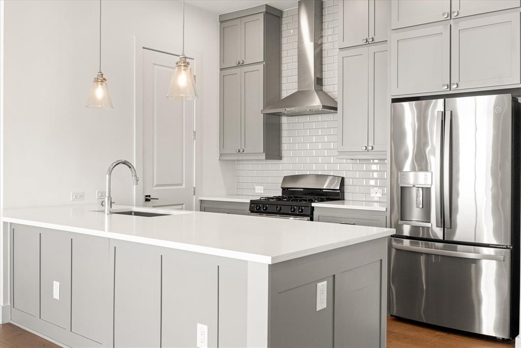 2125 Bird Street Fort Worth, TX 76111 - Photo 3 of 34 a kitchen with stainless steel appliances a sink and a refrigerator