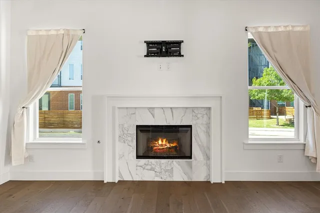 a living room with a fireplace and a floor to ceiling window