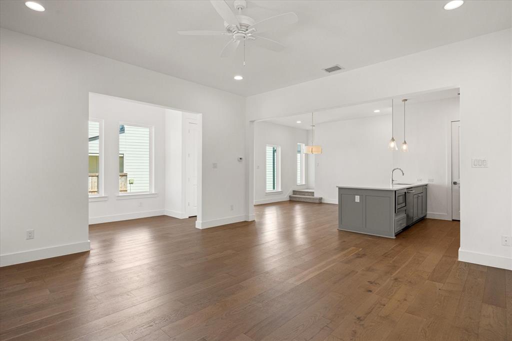2125 Bird Street Fort Worth, TX 76111 - Photo 6 of 34 a view of an empty room with wooden floor and a window