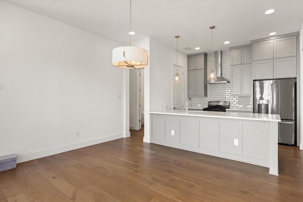 2125 Bird Street Fort Worth, TX 76111 - Photo 10 of 34 a large kitchen with granite countertop a white refrigerator a oven a sink and white cabinets