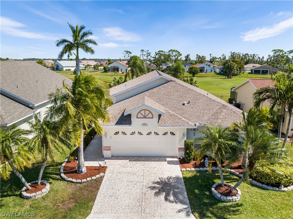 17536 Plumera Lane North Fort Myers, FL 33917 - Photo 1 of 50 a front view of a house with a yard and potted plants