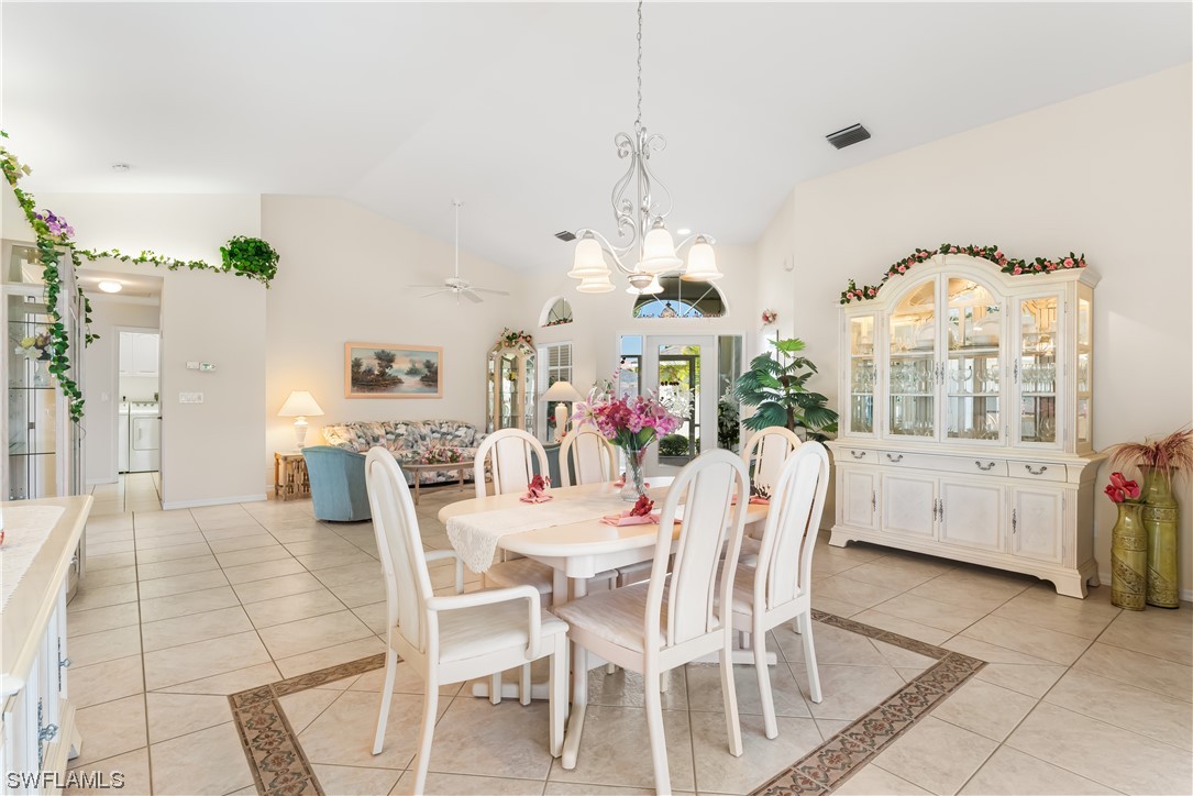 17536 Plumera Lane North Fort Myers, FL 33917 - Photo 13 of 50 a view of a dining room with furniture and a chandelier