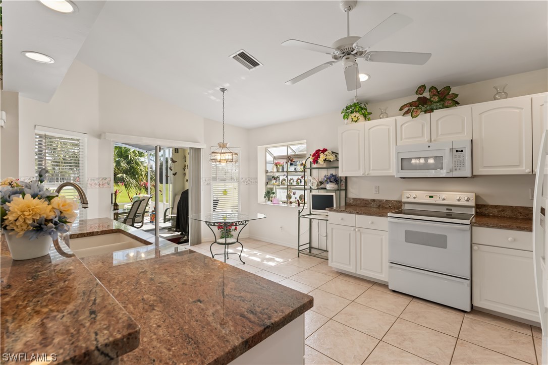 17536 Plumera Lane North Fort Myers, FL 33917 - Photo 14 of 50 a kitchen filled with white cabinets and white appliances