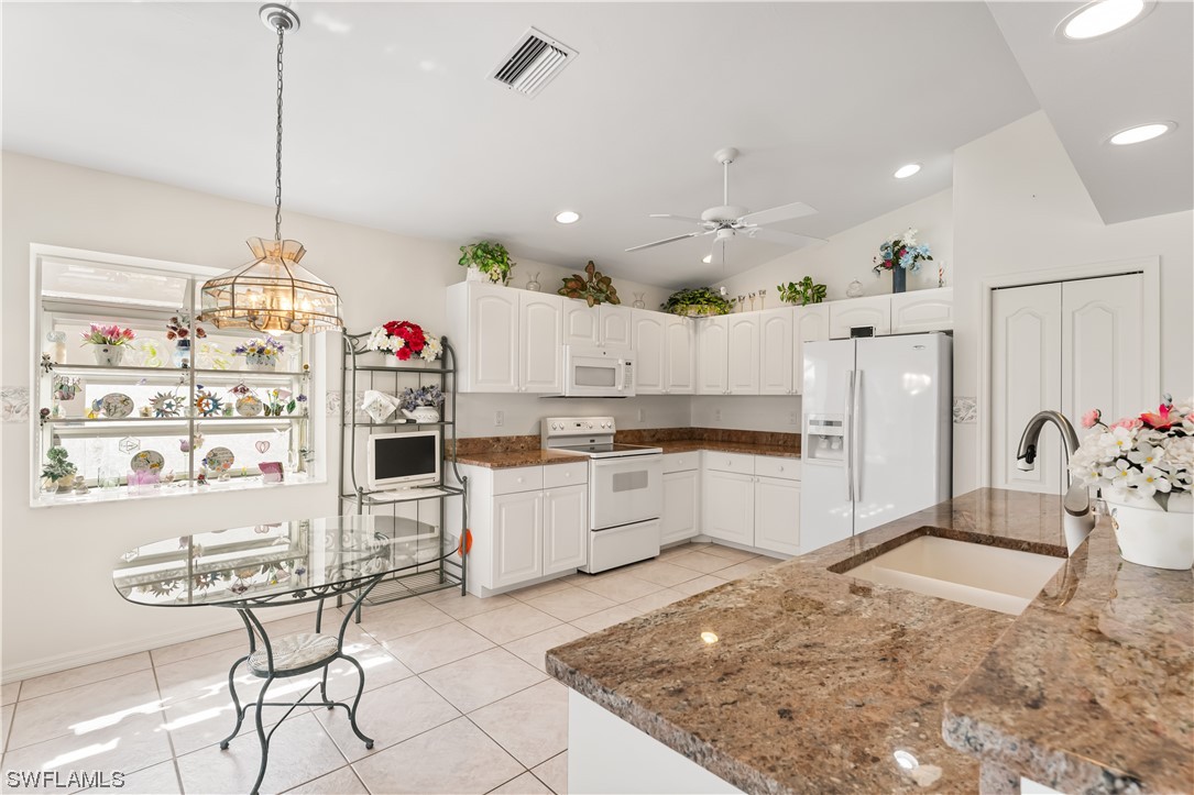17536 Plumera Lane North Fort Myers, FL 33917 - Photo 17 of 50 a large white kitchen with lots of appliances