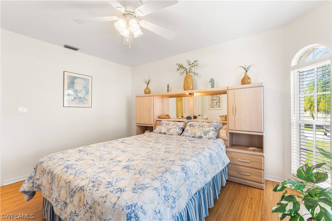 17536 Plumera Lane North Fort Myers, FL 33917 - Photo 28 of 50 a bedroom with a bed and a chandelier