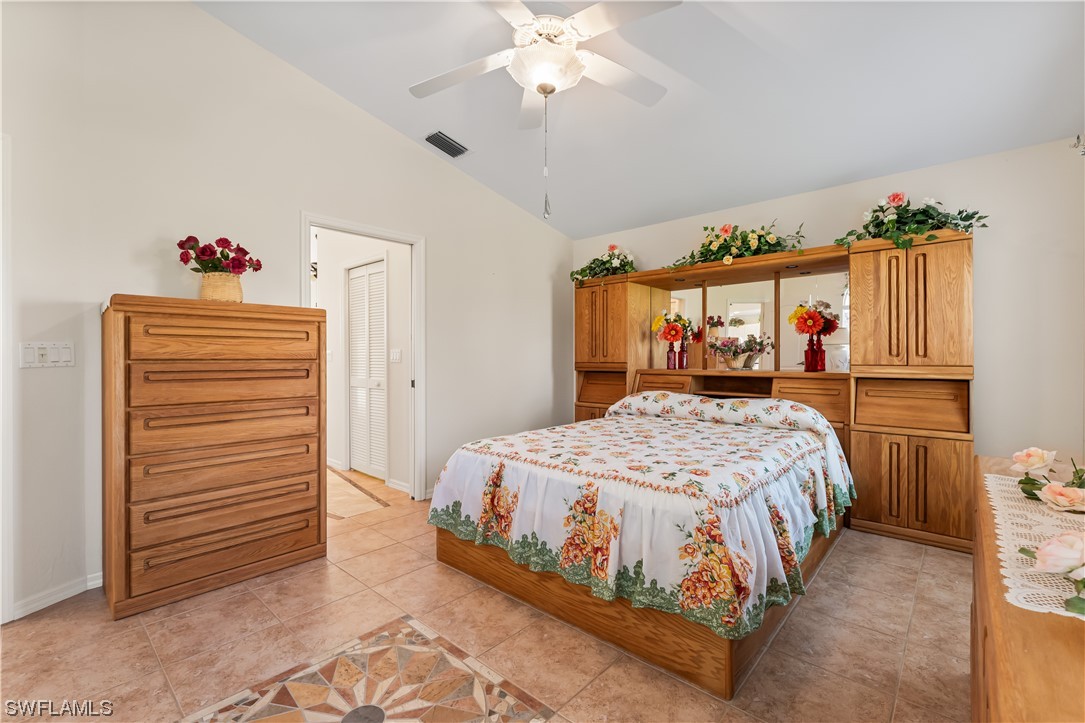 17536 Plumera Lane North Fort Myers, FL 33917 - Photo 31 of 50 a bedroom with a bed and a chandelier