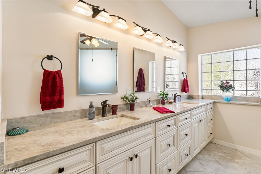 17536 Plumera Lane North Fort Myers, FL 33917 - Photo 32 of 50 a bathroom with a double vanity sink and a mirror
