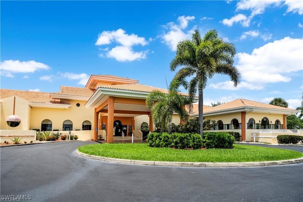 17536 Plumera Lane North Fort Myers, FL 33917 - Photo 45 of 50 a front view of a house with a yard and potted plants