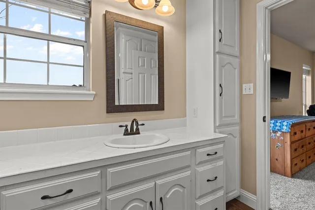 a bathroom with a sink a vanity and a mirror