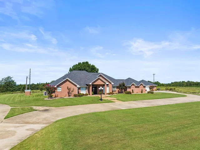 a view of house with garden space and ocean view