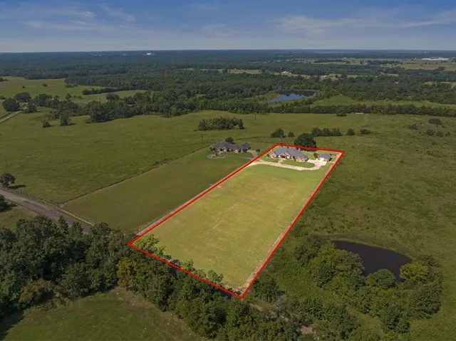 an aerial view of a residential houses with outdoor space