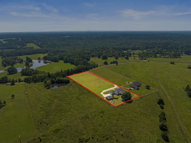 an aerial view of a house with a lake view